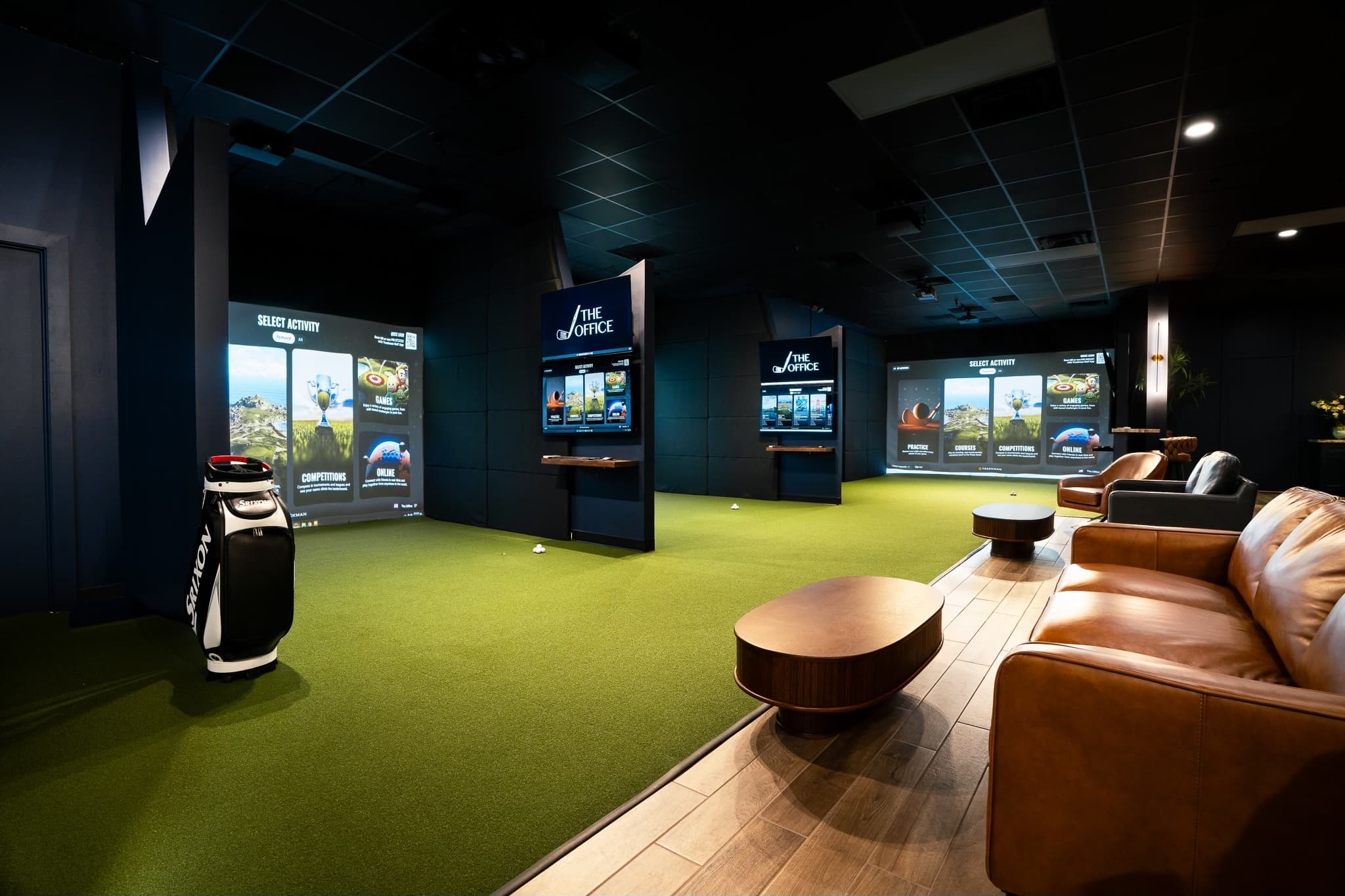 The Office golf simulator lounge with premium TrackMan bays and luxury leather seating